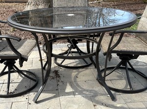 lot 24 image: Glass Top Patio Table with Four Swivel Rocker Chairs