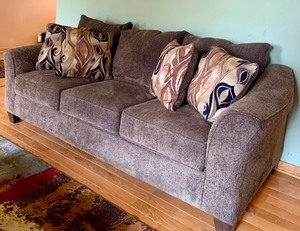 lot 3 image: Pretty Brown Upholstered Sofa with Accent Pillows