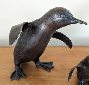 lot 60 image: Three Bronze Penguin Sculptures by Ivana Perkins