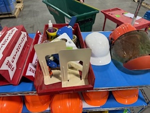 lot 84 image: Bargain Lot of Warehouse Supplies includes hard hats, storage trays, tape guns and more (Cart not included)