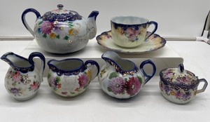 lot 321 image: Nippon Hand Painted Tea Pot, Cup and Saucer, 3 Creamers and a Compote Bowl