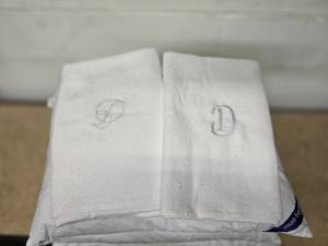 4 feather pillows and 2 bath towels