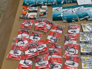 lot 63 image: TABLE FULL OF HOOKS, RIGS, LINE, SPOONS, RODREEL, & HOOKS