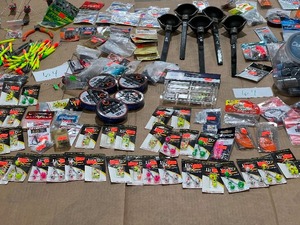 lot 64 image: TABLE FULL OF JIGS, WEIGHTS, HOOKS, RIGS, ODOR-OFF, RODS, LEADERS, & LINE