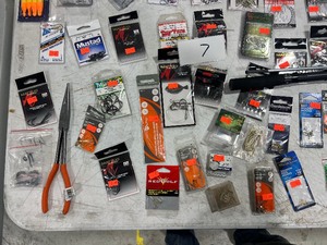 lot 7 image: TABLE FULL OF HOOKS, LINE, AND ROD