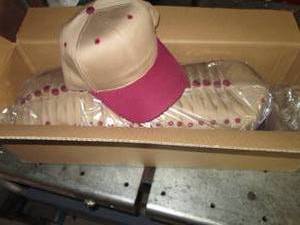 Case of KhakiMaroon snapback baseb...