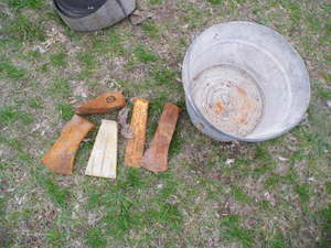 Metal pail with assorted ax heads...