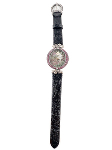 lot 15 image: Ladys Barbara Bixby Genuine Rhodolite Garnet Bezel. Mother Of Pearl Grey Skull Face. 18K Gold Flower Embellishment On Face. Silver Clasp & Embellishments On Strap. Quartz Analog watch. Working