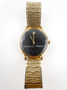 lot 198 image: Mens Clinton Watch Co. Personalized Black Dial With Alfred J. Hudson On Dial Yellow Stainless Steel & Base Metal Quartz Analog watch. Working