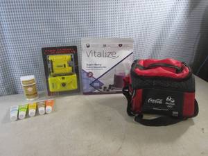 lot 317 image: (D-3) Lume Deodorant, Focus CameraBinoculars, Vitalize Super Berry Protein Smoothie Mix and Small Insulated Coca-Cola Cooler Bag