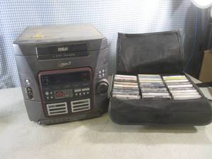 lot 103 image: (EW4) RCA RS2625 AMFM, 5-Disc Changer, Dual Cassette with Case of Cassette Tapes - Powers On