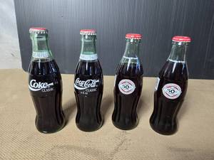 lot 65 image: Lot of 4 Coke Bottles - 2 are 50th Anniversary