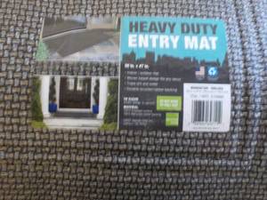 lot 138 image: Heavy Duty Entry Mat 30 x 47- has damage on back as shown - doesnt affect function