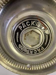 lot 144 image: Three Vintage Packard Hubcaps