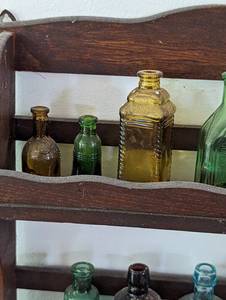 lot 39 image: Small Vintage Wood Shelf with Colorful Glass Bottles