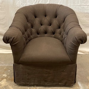 Dark brown tuft swivel chair.