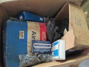 Large box full of assorted Atlas air filters, marker crayons and more