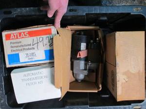 Heavy Duty Storage Tote with assorted Atlas Starters and other automotive supplies