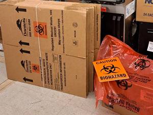 lot 216 image: (2) Bundles of BIO-Hazard Box Flats 15-count, Box of BIO-Hazard Bags and CAUTION Signs