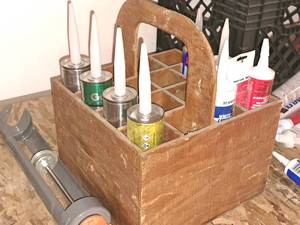 lot 438 image: Lot of (9) Tubes of Assorted Caulk with Wooden Carry Tote - Vulkem 116 Sealant, geocek 3300 Professional Sealant, Loctite Foambaord Construction Adhesive, White Lightning 3006 Quick Dry, Premium Kitchen and Bath Sealant