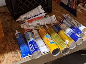 lot 439 image: Lot of (16) Assorted Sealants & Adhesives with Tote - Loctite Foamboard, Liquid Nails, Vulkem 116, Sika Pro Select, DAP and more