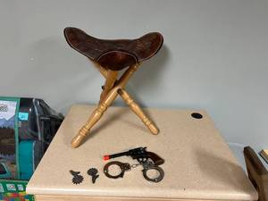 lot 299 image: Cap Gun, Saddle Stool & Toy Handcuffs