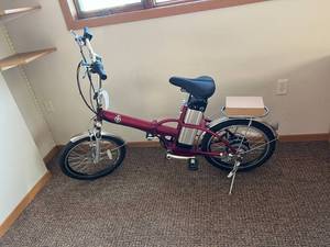 lot 551 image: NOS Red Foldable Electric Bike with Charger & Battery