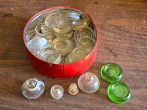 lot 316 image: Tin of Glass Caster Cups (Furniture Movers) 2 of them  Uranium Glass