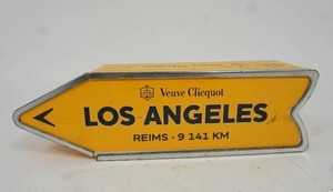 lot 27 image: Veuve Clicquot Limited Edition Journey Arrow Collection Los Angeles Reims-9 141 KM Directional Arrow Advertising Street Landmark Tin Box...