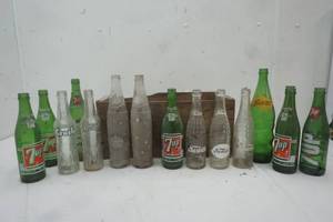 lot 35 image: Wood Crate with a Variety of glass soda bottles ( Crush, 7up, Nesbitts, Squirt)