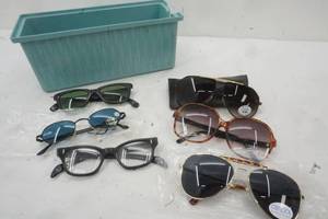 lot 317 image: New and Used Sunglasses in a Blue container