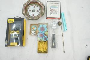 lot 494 image: Home Decor, Bowl, Vintage 8 Track Sound of Music, bag clip, candle snuffer, matches and Otter Box for iPhone XR
