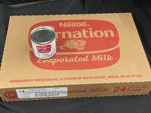 lot 142 image: Nestle Carnation Evaporated Milk 24 X 5 oz Cans