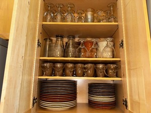 lot 19 image: Entire Contents of Kitchen Cabinet including Wine Glasses, Parfait Cups, Place Setting for 13 of Rachel Ray Cuccina Handpainted Dinnerware Plates, Mugs, Salad Plates, and Bowls
