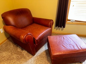 lot 23 image: Beautiful High Quality Custom Made for Sofas & Chairs Aniline Leather Chair and Ottoman Measuring 38 x 36 x 34