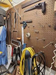 lot 72 image: Wall of assorted Tools, Hand Saws, Extension Cords, ETC.