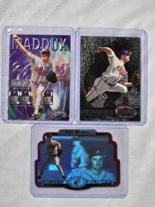 lot 152 image: Lot of 3 Greg Maddux 1996 Upper Deck SPX Holo Die Cut, 1998 Fleer Thunder Insert No. 12 of 20, 1997 Fleer Metal Universe No. 33