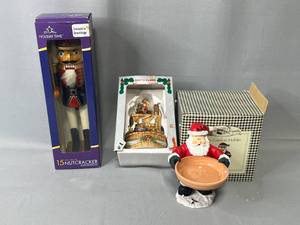 lot 37 image: Holiday Decor - Santa Cookie Holder, Musical Porcelain Santa Clause and a Nutcracker