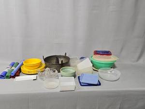 lot 61 image: Tupperware Storage Containers (most w lids), Incomplete Sets of Plastic Plates & Bowls, Bundt Cake Pan, Glass Juicer, Baking Mats