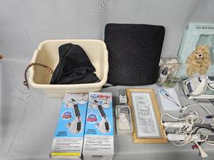 lot 64 image: Make Up Bag Hanging Organizer, Make Up Bags, 4 Curling Irons, Clothes Iron, Foot Bath, Bathroom Suction Handles, Back Pillow, Candle & More