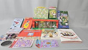 lot 152 image: Lot of 6 Peanuts Books Inc 1966 The Red Baron, Charlie Browns Christmas Tales CD, Peanuts Pastel Trinket Box w Snoopy Watch, Playing Cards & Stickers, Peanuts Holiday Pint Glass (4 Pack)