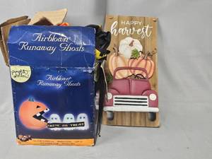 lot 114 image: Airblown Runaway Ghosts Halloween Decor Blow Up- unknown condition and Happy Harvest Wooden Sign