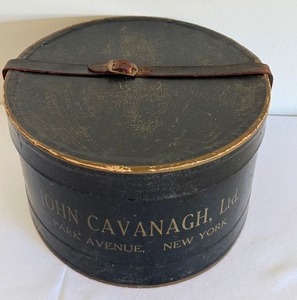 lot 112 image: Vintage John Cavanaugh, Ltd Circular Hat Box with Leather Strap