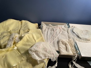 lot 136 image: Vintage Penney Christening Set with Baby Caps and Yellow Bunting