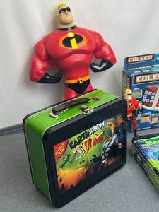 lot 77 image: Toy Lot - Lootcrate Exclusive Earthworm Jim Metal LunchboxMr. Incredible 15-inch Talking Action FigureColeco Video Game SystemBen 10 Omnitrix and More
