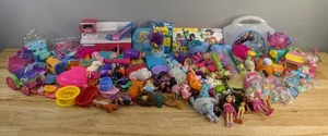 lot 99 image: Miscellaneous Assortment of Doll Accessories, Trolls, Care Bear, Peppa Pig, Wizard of Oz, Dr.Seuss, Teen Titans Go, Frozen, Play Set Toys, Etc. E