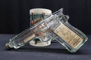 lot 84 image: COLLECTIBLE 9MM GUN SHAPED BOTTLE  MUG