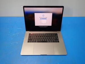 lot 31 image: Apple&nbspA1990 MacBook Pro 15,1 &nbspINTEL CORE I7-8750H 2.2 Ghz  16GB DDR4 SDRAM  500GB SSD  15.4 screen with 2880 x 1800 Resolution  Includes IOS and chargers  deep scratch on screen, few chips in bottom bezel