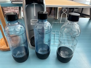 lot 63 image: Soda Stream with Three Bottles, Wire Napkin Holder and Wood Paper Towel Holder