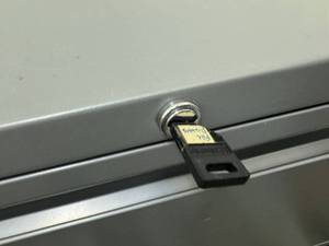 lot 121 image: Gray Four Door File Cabinet with Key